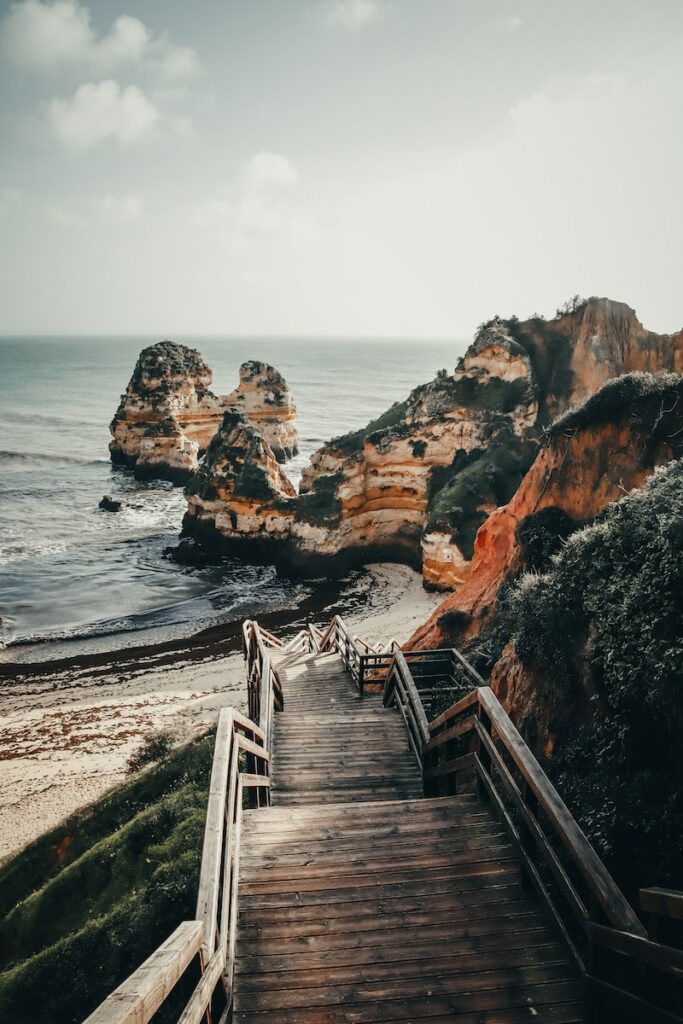 a wooden staircase leading down to the beach
